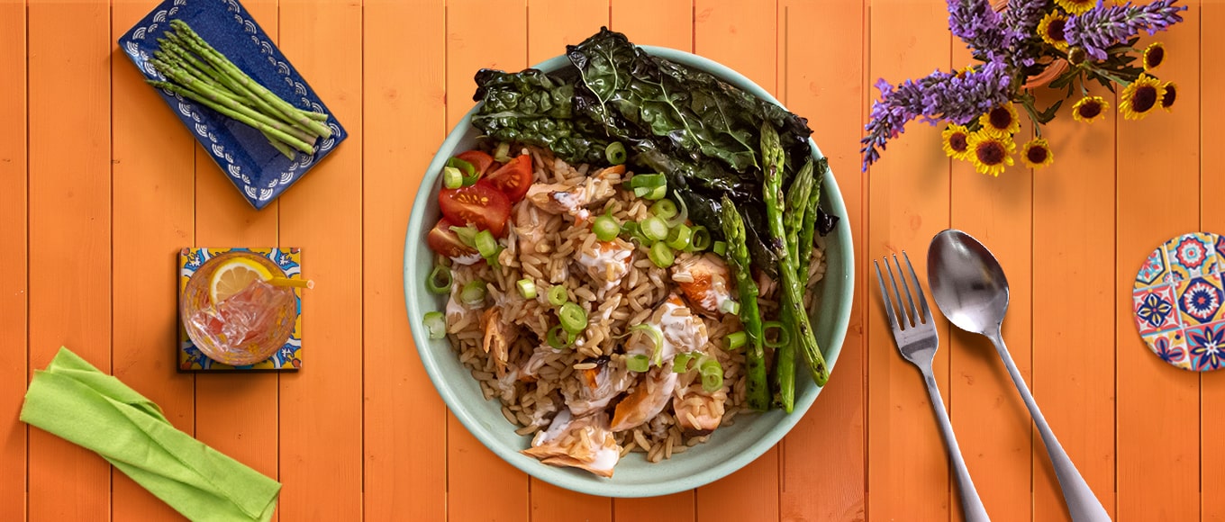 A bowl of delicious bowl of salmon and rice made from a recipe that takes less than 25 minutes to make.