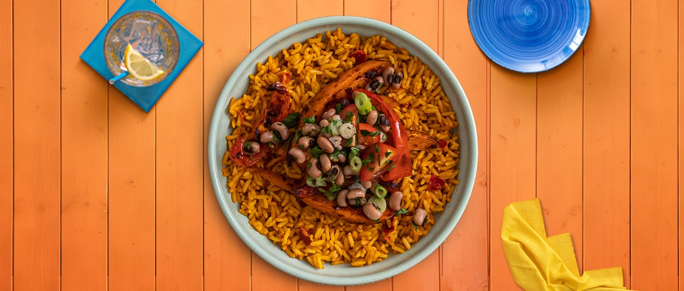A bean and sweet potato burrito bowl recipe made in less than 45 minutes with a stovetop, microwave, and oven.
