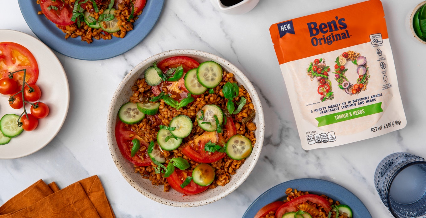 Ben's 10 Medley rice package - Tomato & Herbs flavor - on table next to plates of Tomato Cucumber Salad
