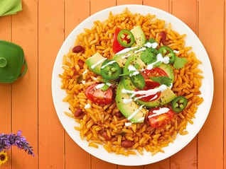 A classic bean burrito bowl recipe with chipotle dressing made in less than 30 minutes with a stovetop and microwave.