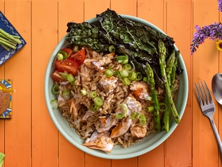 A bowl of delicious bowl of salmon and rice made from a recipe that takes less than 25 minutes to make.