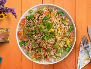 A rice salad recipe with colorful veggies, a tangy vinaigrette, and delicious rice.